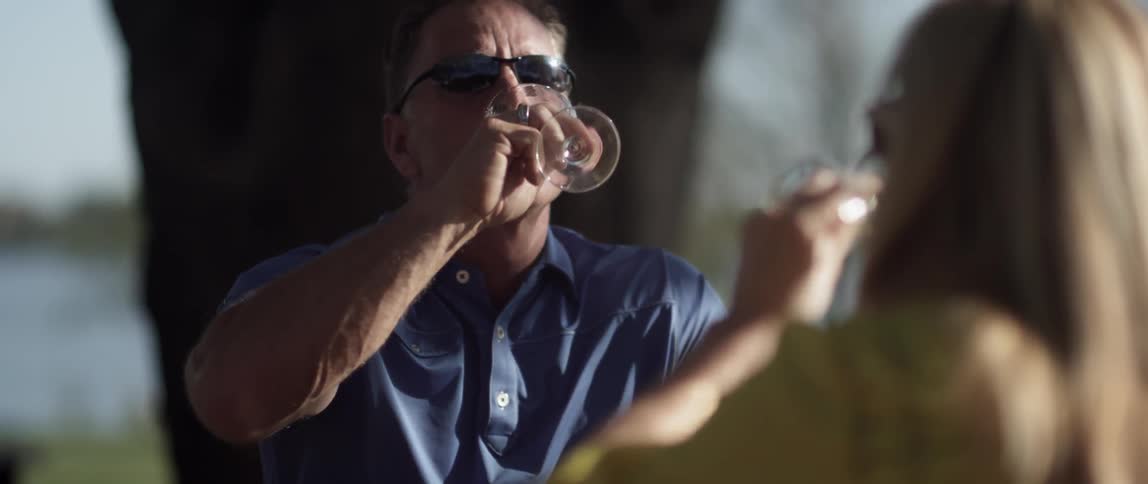 A man and woman toast with glasses of wine