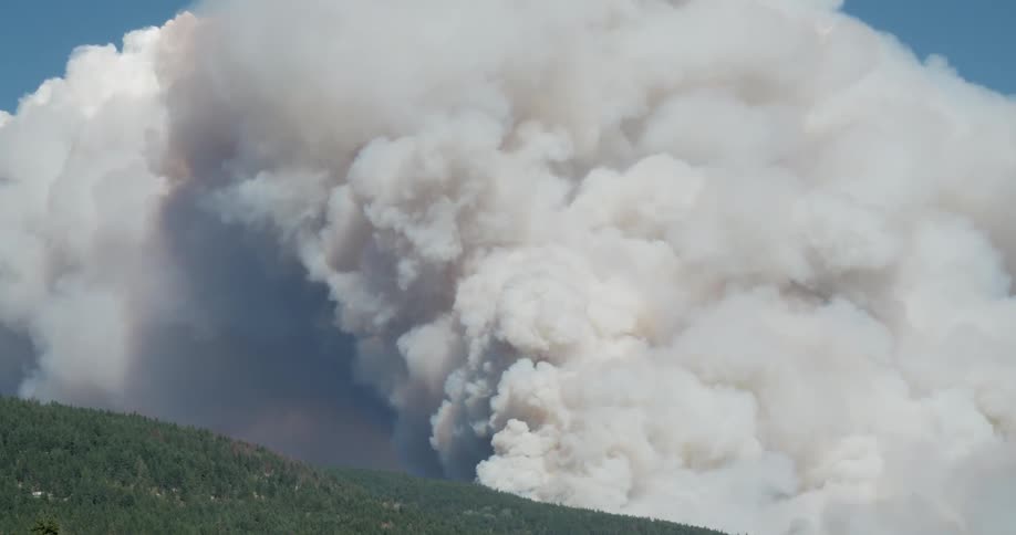A volcano is throwing white smoke into the air