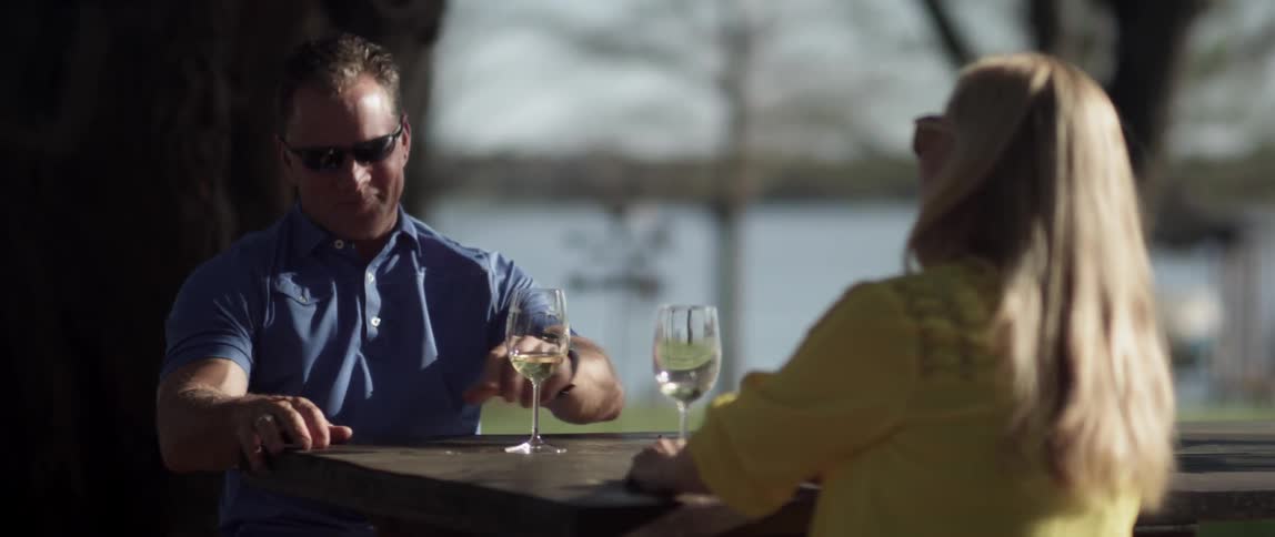 A couple drinks outside, then leaves