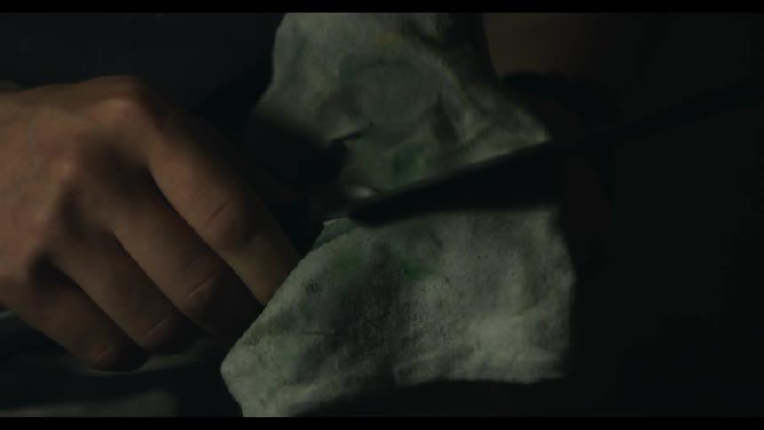 A man is wiping down a knife