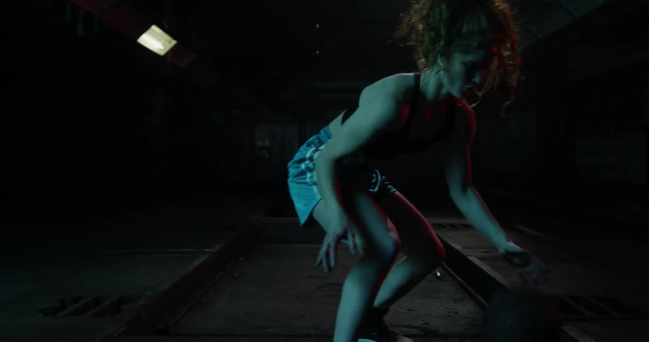 A female athlete is practicing her basketball skills