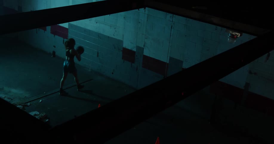 A woman bounces the ball against the wall