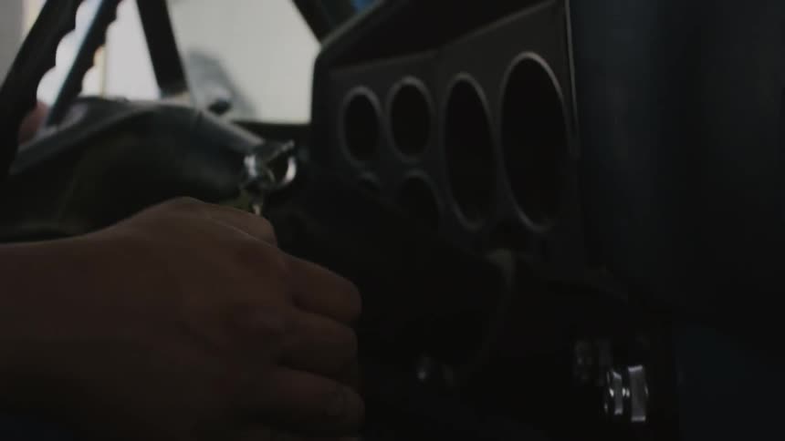 A driver shifts gears while driving a vehicle