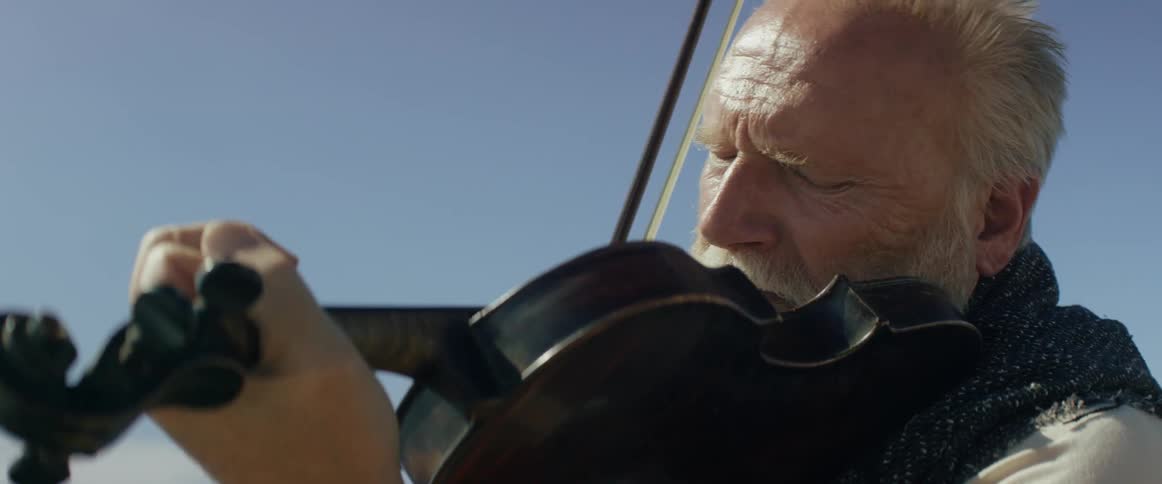 A man is playing the violin