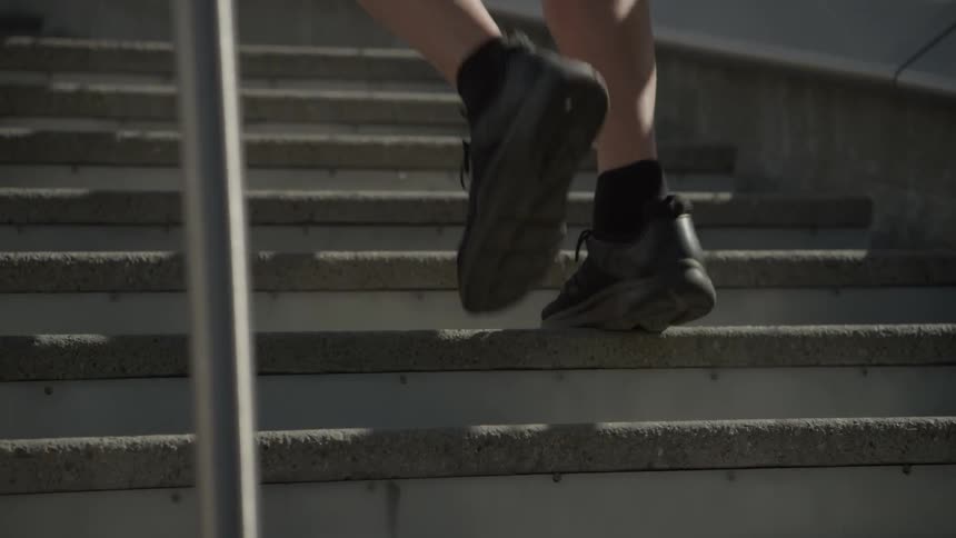 A man jogs up and down steps