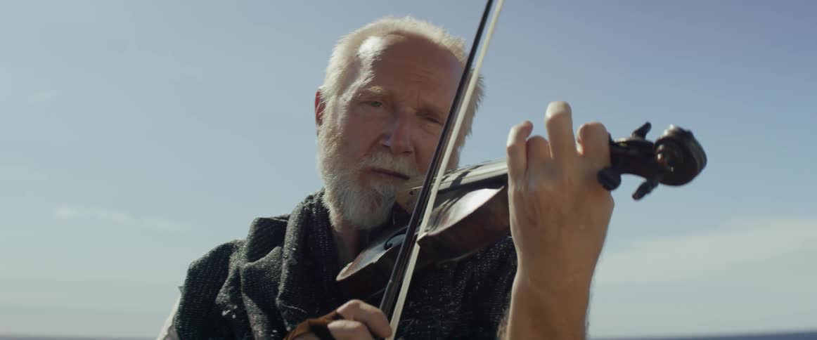 A man is having fun playing the violin