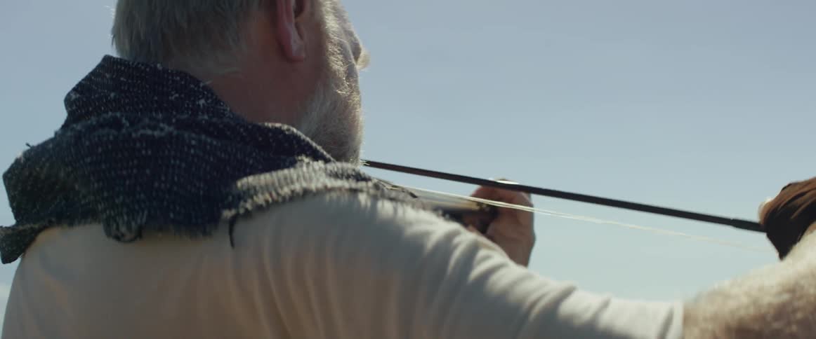 A man plays violin outdoors