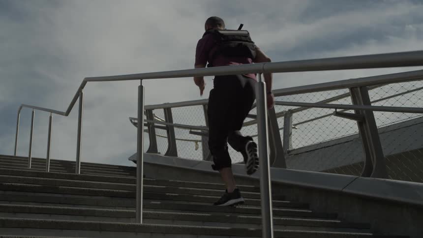A man is running up the steps