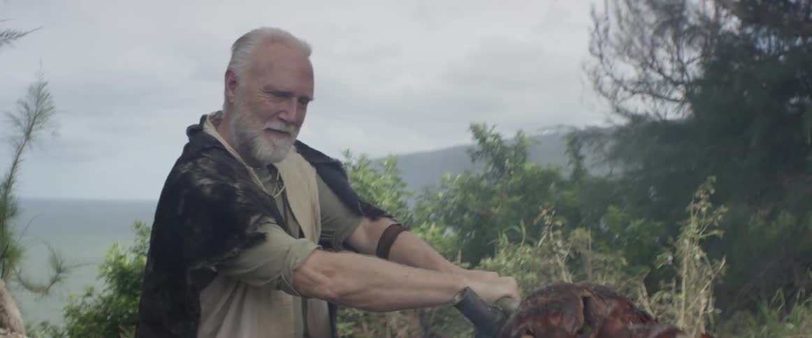 A man is standing outside holding onto an object
