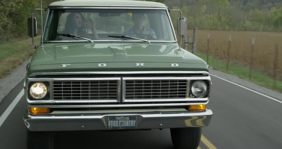 A man and woman talk in a pickup while he drives
