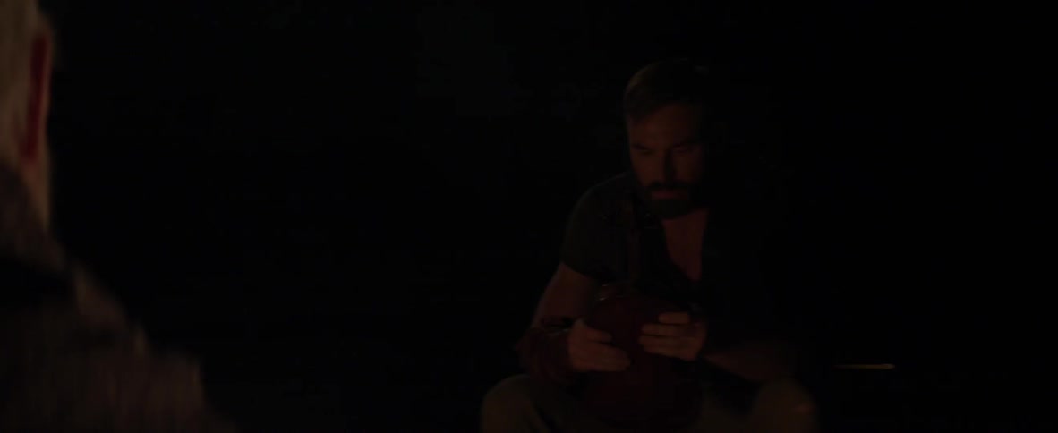 Man illuminated by dim light at night