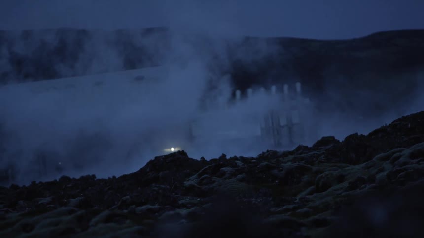 Steam rises near a factory located in the mountains