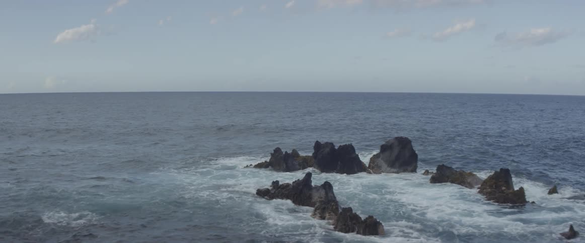 Ocean waves splash and break on the rocks