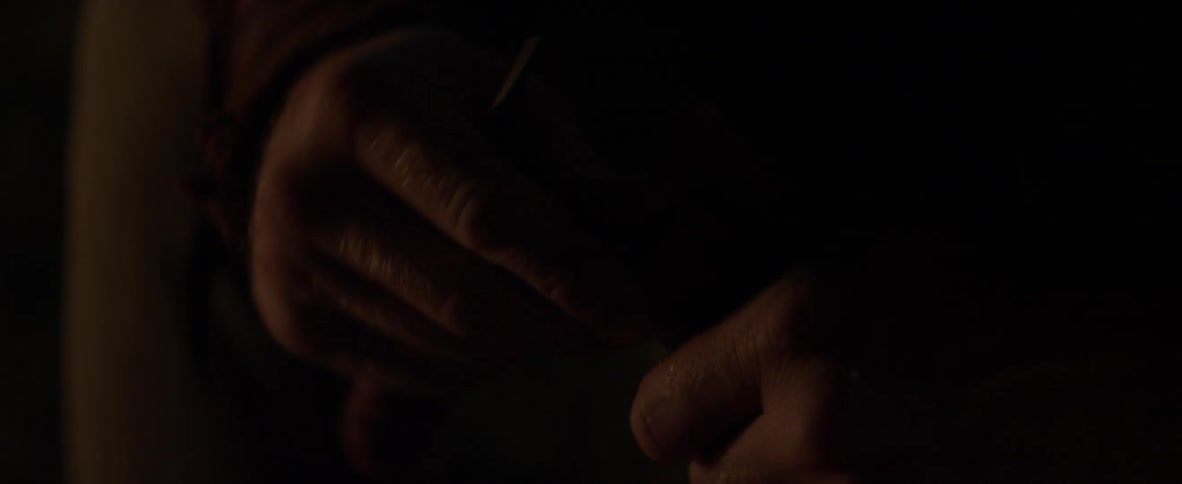 A man is carving out a piece of wood