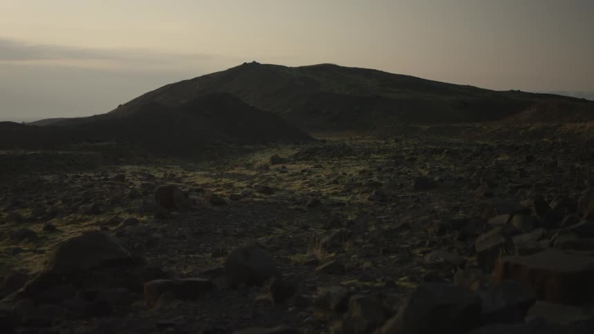 A mountainous landscape at sunset