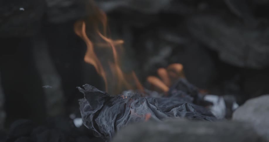 Some items burning in a fire giving off ashes