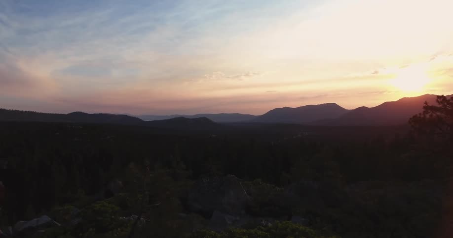 The sun is setting over the mountain ahead