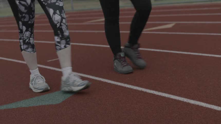 Two people walking on a track
