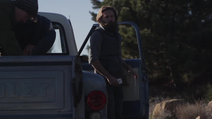 Several people exit an old chevrolet pickup truck