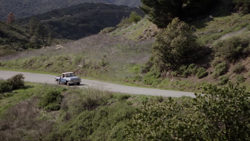 A truck driving down a dirt road