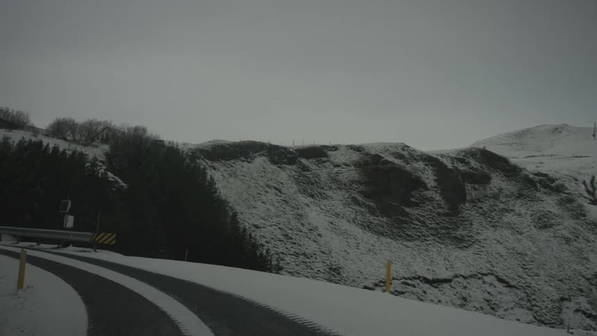 Travelling on a snow covered narrow road with beautiful snow covered mountains in the background