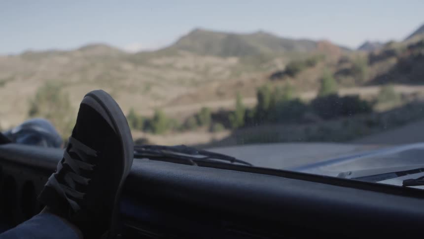 A foot rests on a dashboard