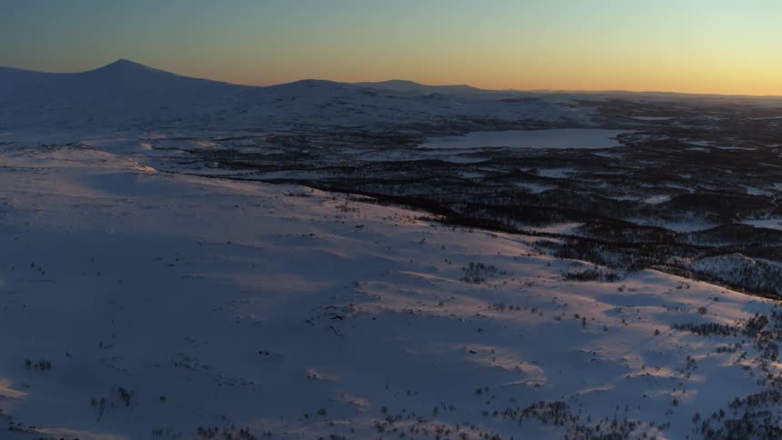 Snow covered hills at sunset