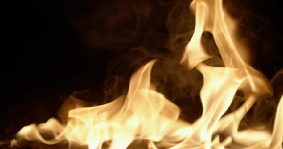 Flames of fire burning in pitch black darkness of night