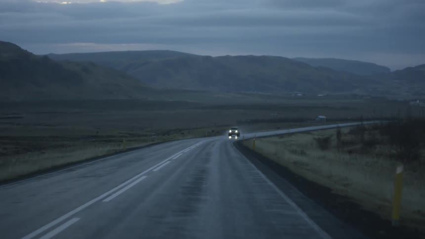Driving along a remote highway in mountainous terrain