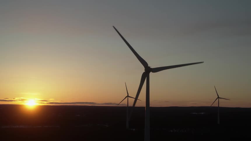 Wind turbines are spinning in the sunlight