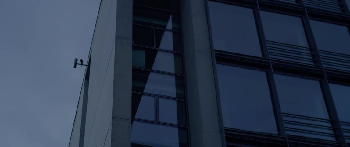 A camera sits mounted on the side of a building
