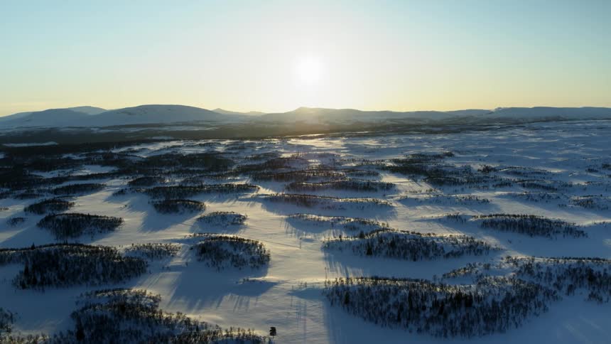 Frozen landscape being filmed by a drone