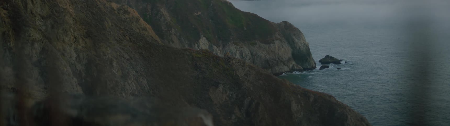 Waves gently roll into the rocks