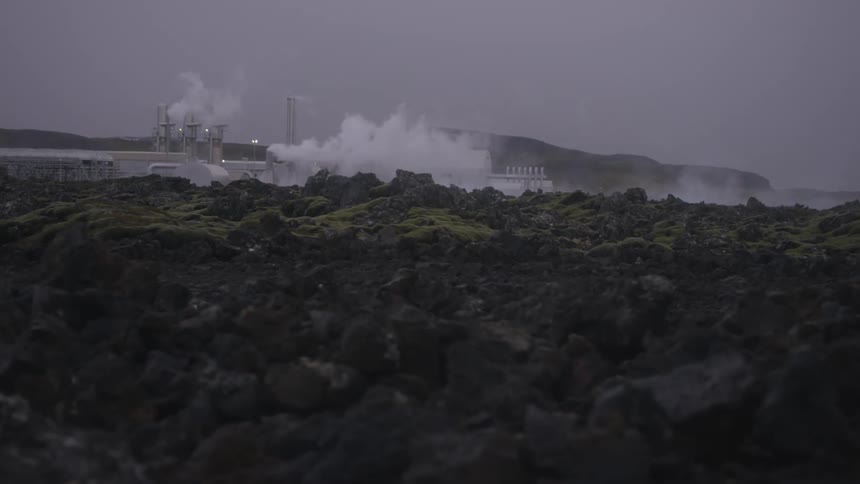 Smoke is being emitted from multiple factory chimneys