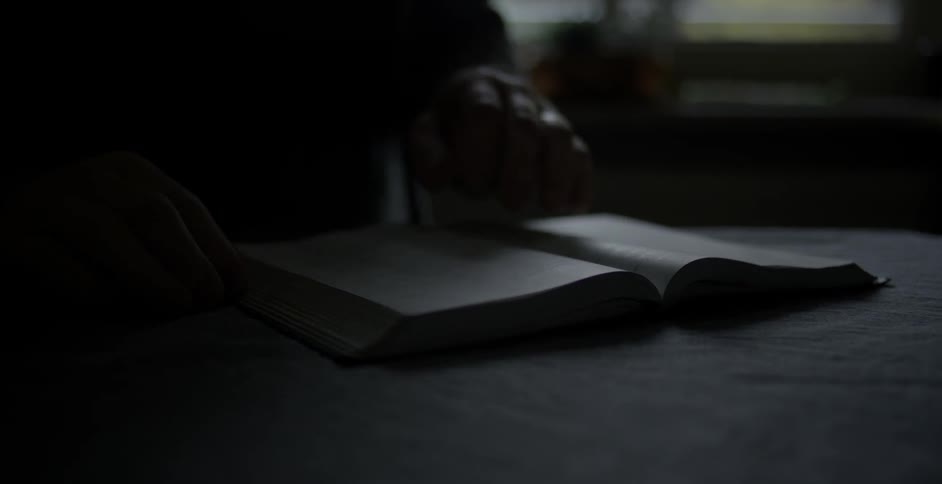 A person is reading a book slowly
