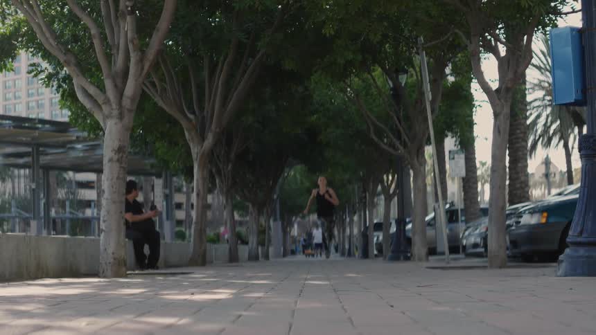 Woman runs down a city street