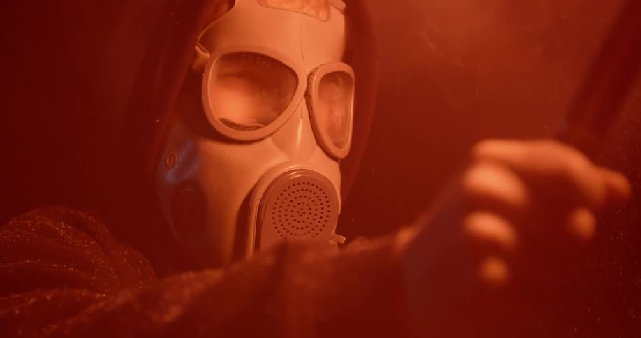 A man in a mask is holding a burning flare