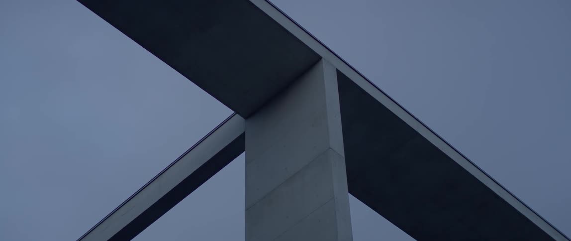 A concrete structure stands overhead