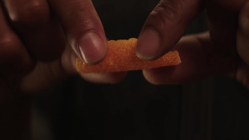 A person squeezes a piece of food