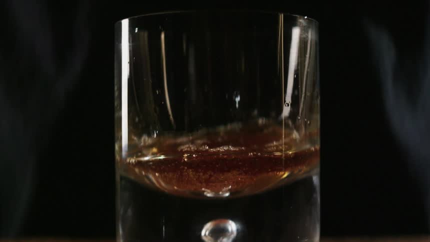 Alcohol is poured into a glass