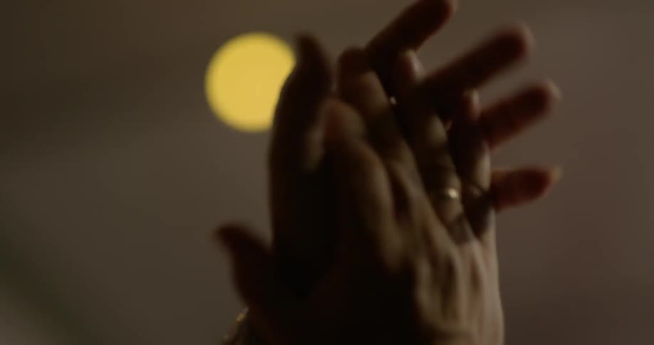 A person claps their hands slowly