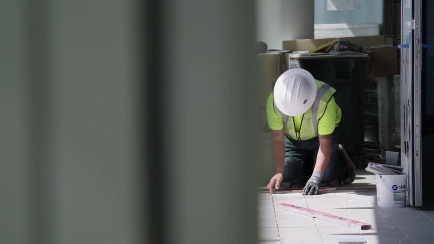 A man is laying tile
