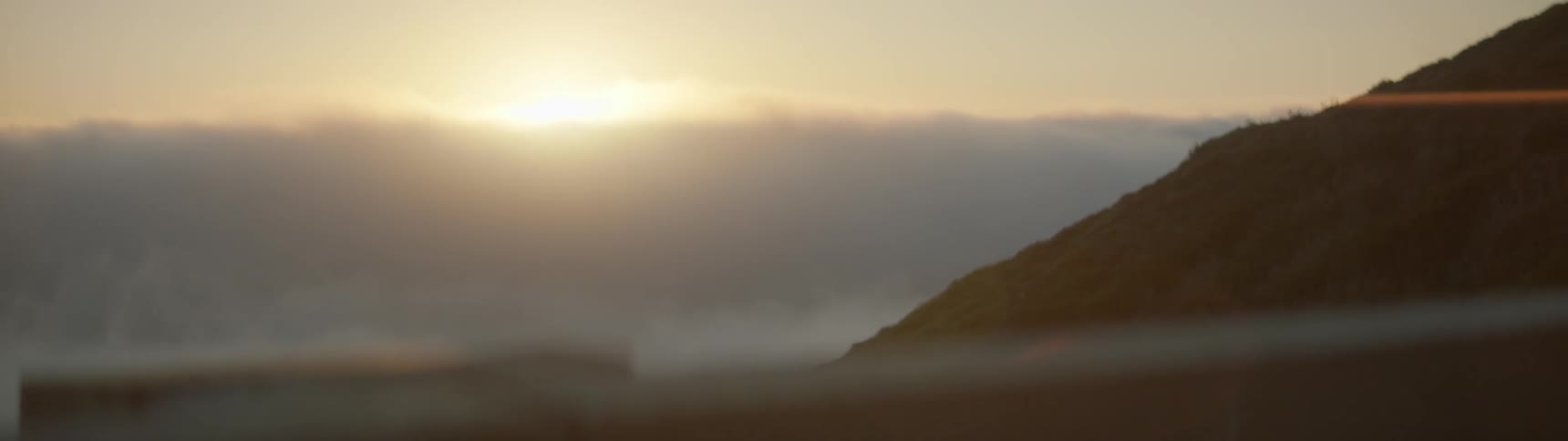 The sun is starting to set behind the clouds ahead