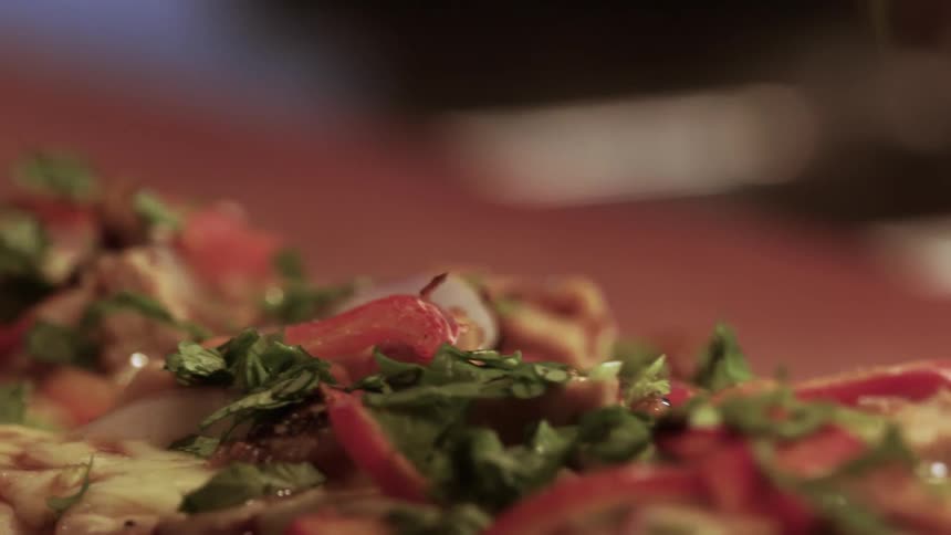 Ingredients are being placed on a dish
