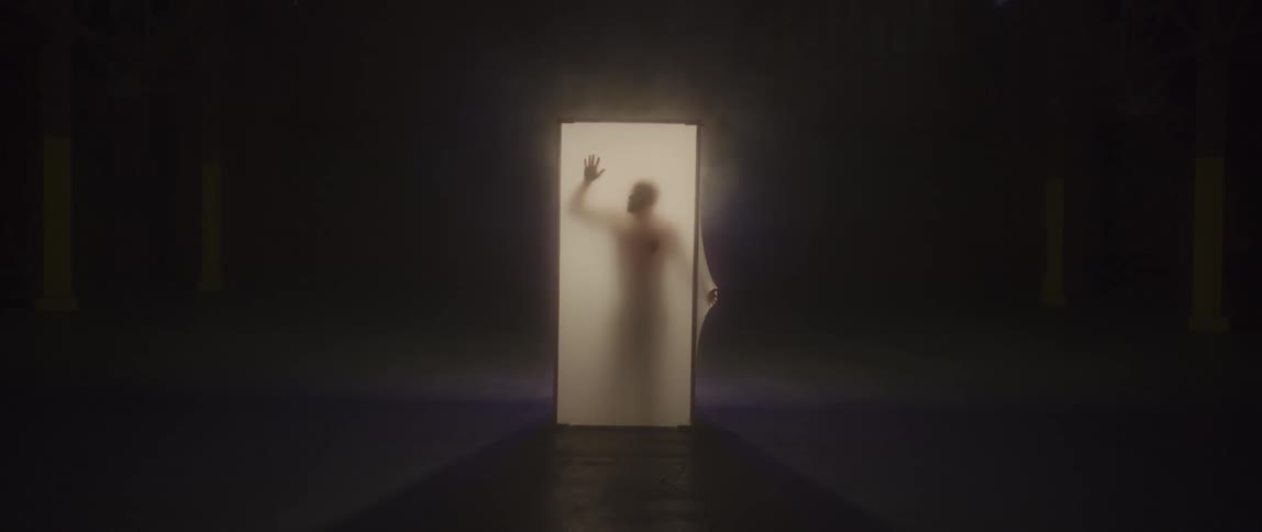 A person dances in a translucent box