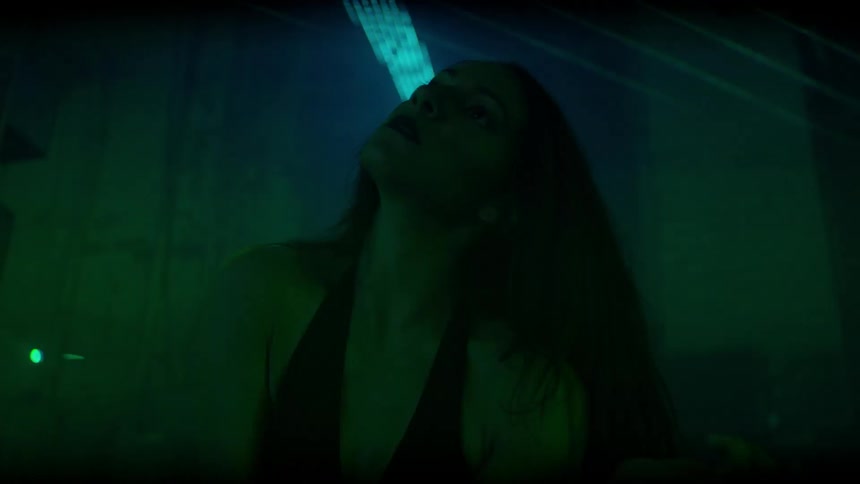 Woman moves her head and arms around with lasers flashing