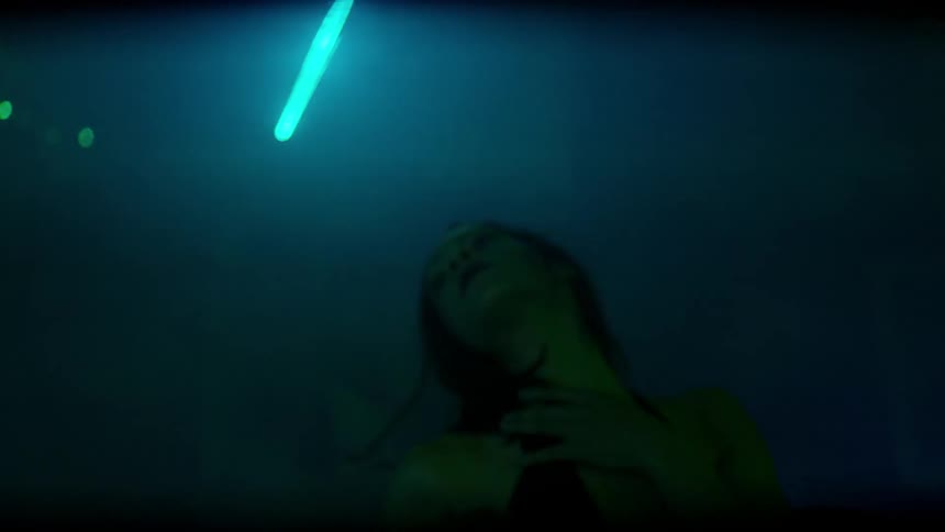 Woman dances with lasers flashing