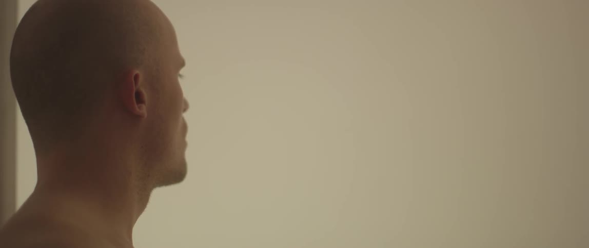 A bald man is looking down
