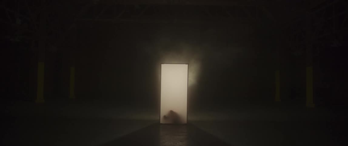 White screen with smoke above it and a shadow behind it