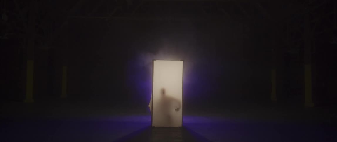 A person is trapped inside a small white cube